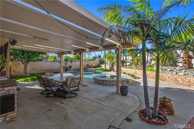 a view of a patio with table and chairs potted plants with wooden fence