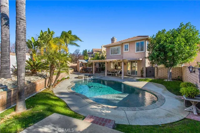 a view of a house with swimming pool and sitting area
