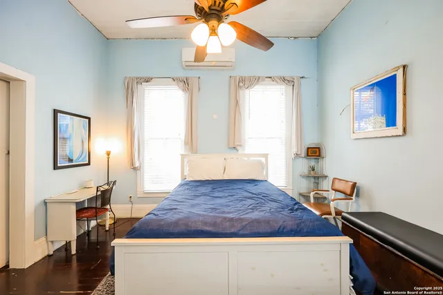 a bedroom with a bed and a chandelier
