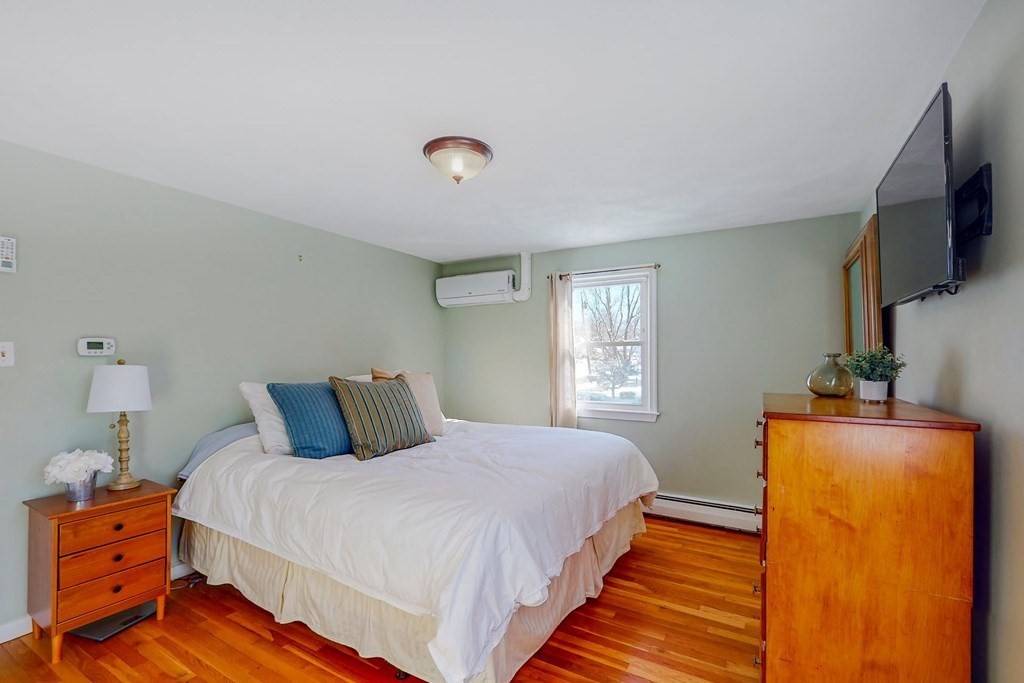 19 Longmeadow Road Medfield, MA 02052 - Photo 8 of 30 a bedroom with a bed and a flat tv screen on dresser