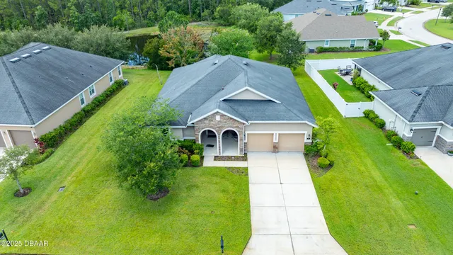 a aerial view of a house with a yard