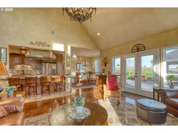 a living room with lots of furniture and a large window