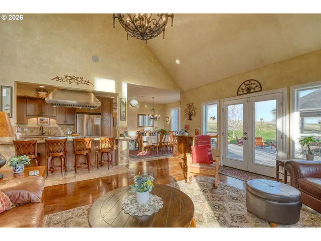 a living room with lots of furniture and a large window