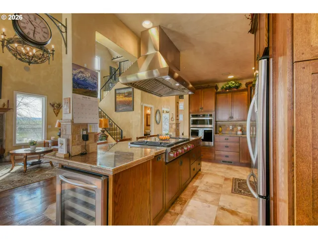 a kitchen with stainless steel appliances granite countertop a sink and cabinets