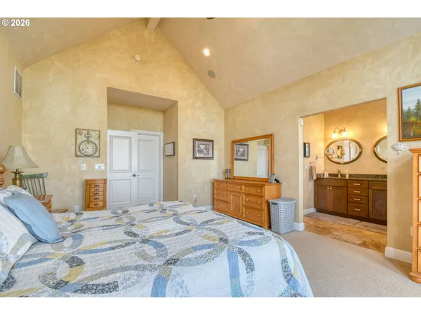 a bedroom with a bed and dresser with mirror