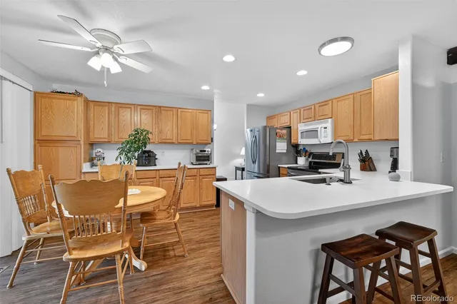 a view of kitchen with cabinets table and chairs