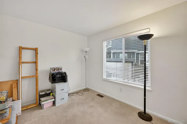 a view of a livingroom with furniture and a window