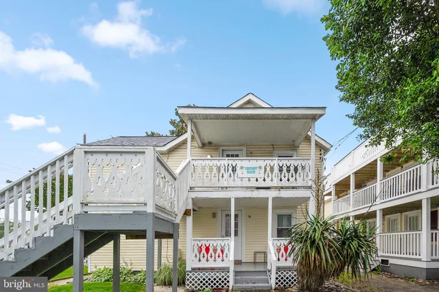 a front view of a building with a garden