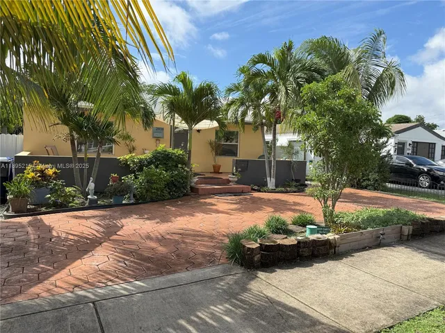 a view of a house with backyard and sitting area