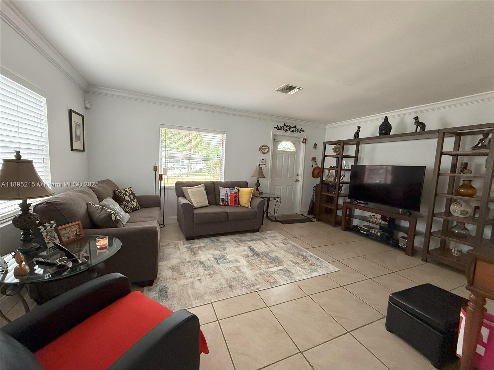 2808 Rodman Street Hollywood, FL 33020 - Photo 3 of 19 a living room with furniture and a flat screen tv