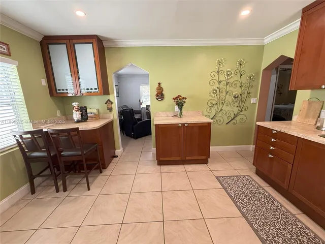 a room with a couch and a view of kitchen