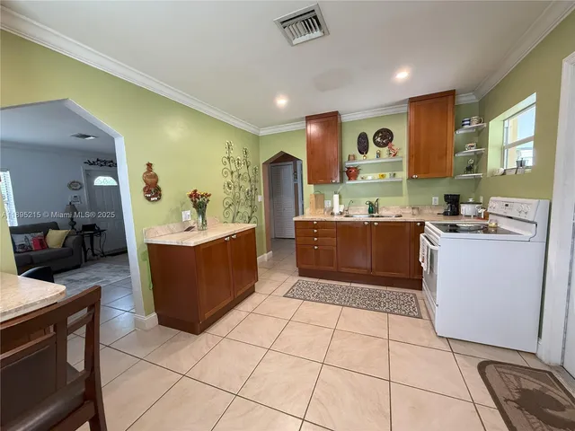 a kitchen with stainless steel appliances kitchen island granite countertop a sink and cabinets