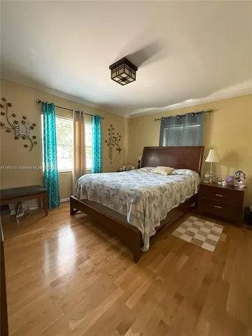 a bedroom with a bed and window