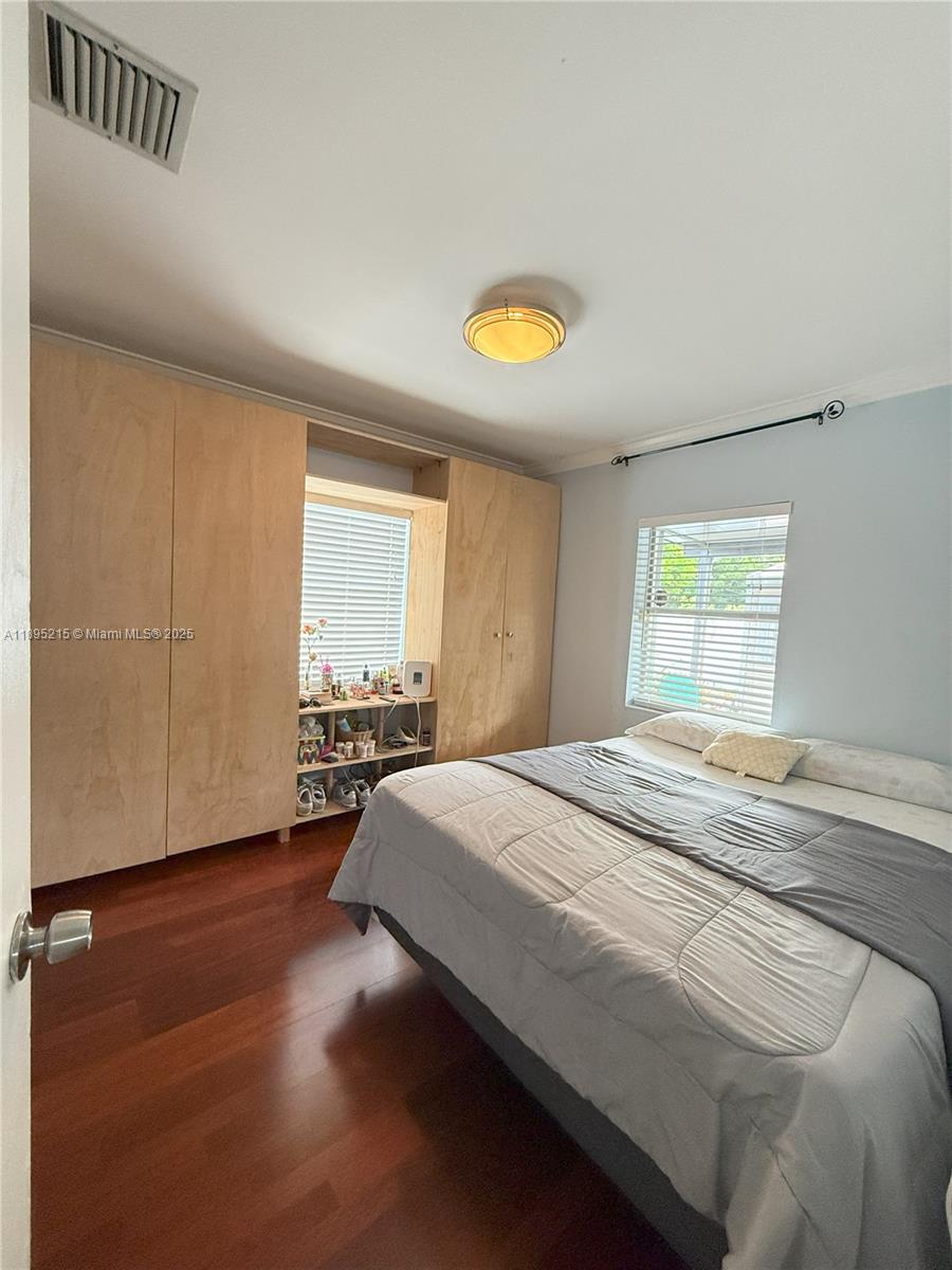 2808 Rodman Street Hollywood, FL 33020 - Photo 8 of 19 a bed sitting in a spacious bedroom next to a window