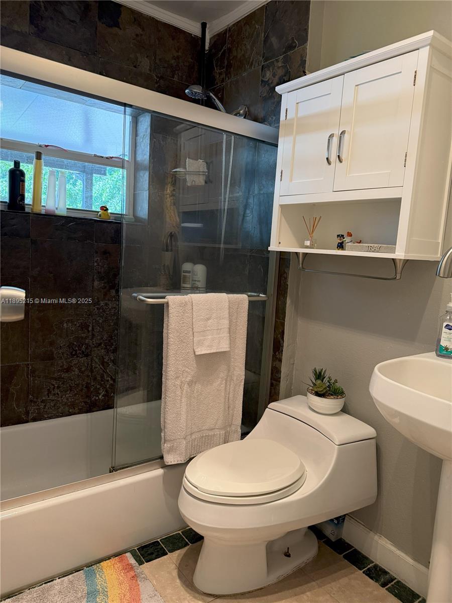 2808 Rodman Street Hollywood, FL 33020 - Photo 9 of 19 a bathroom with a toilet a sink and bathtub