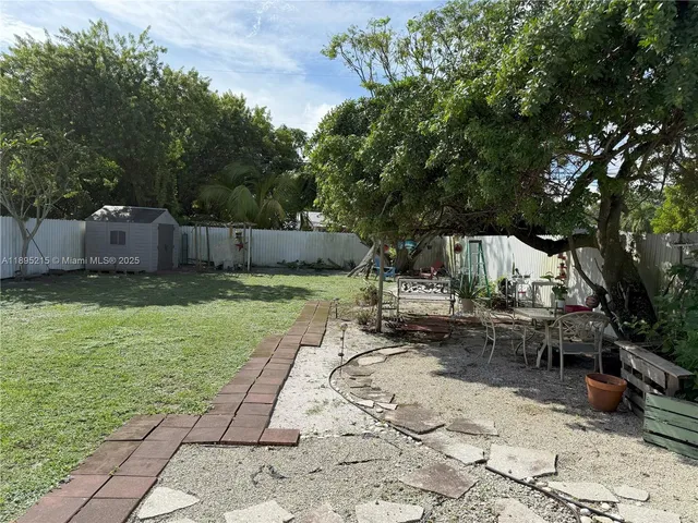 a view of a backyard with a sitting area