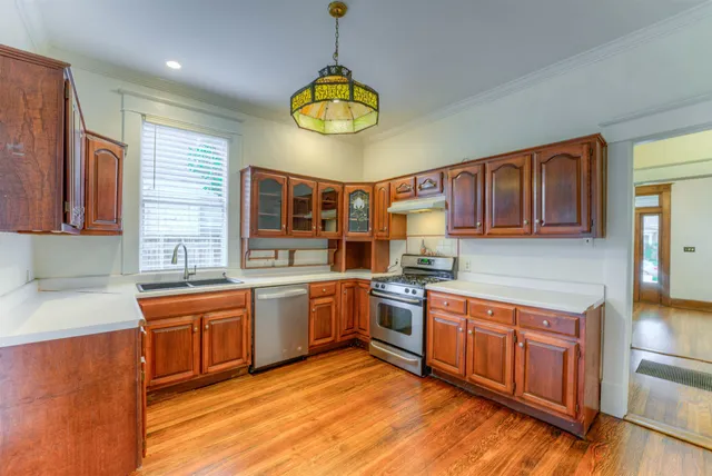 a kitchen with stainless steel appliances granite countertop a stove and a sink