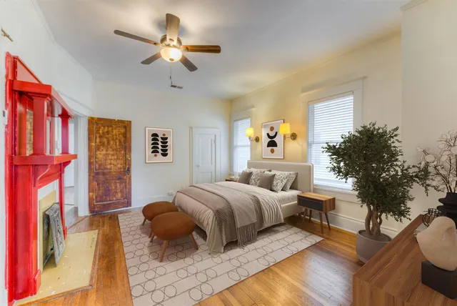 a bedroom with a bed couch and a chandelier