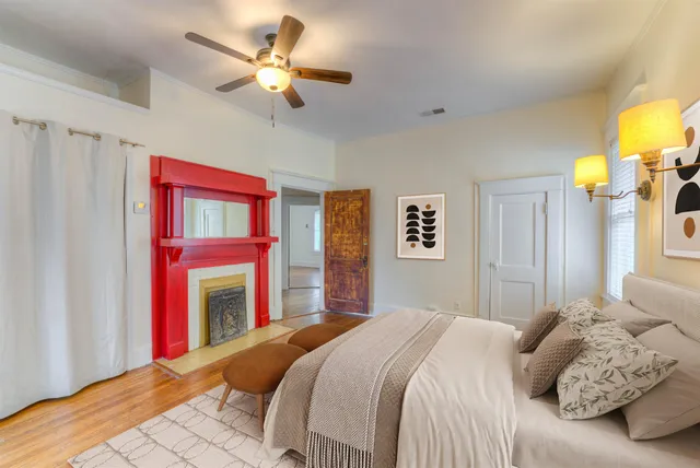 a bedroom with a bed and a chandelier