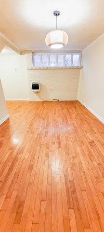 a view of a room with wooden floor and cabinets