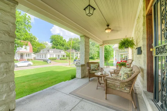 a living room with patio furniture and garden