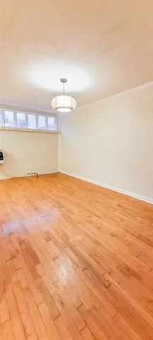 a view of a big room with wooden floor and city view