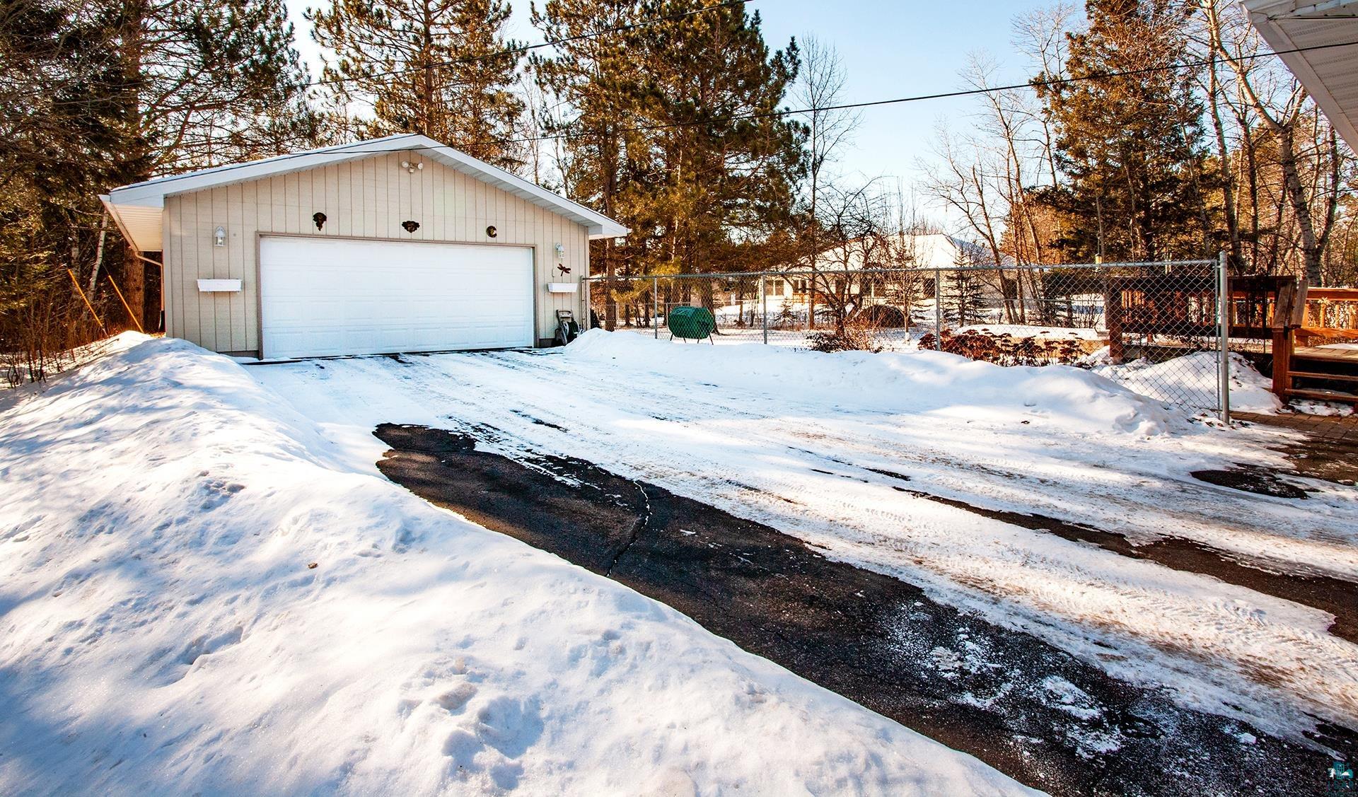 318 Marshall Street Duluth, MN 55803 - Photo 3 of 18 Yard layered in snow with a garage and an outdoor structure