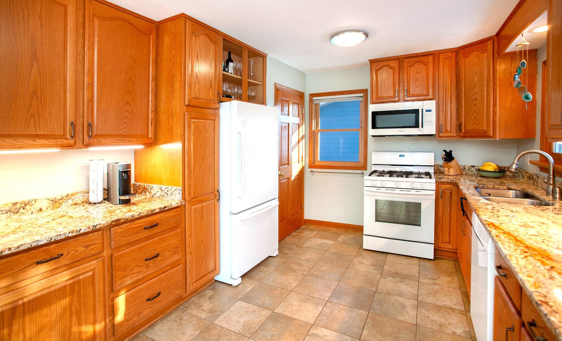 318 Marshall Street Duluth, MN 55803 - Photo 7 of 18 Kitchen with white appliances, light stone countertops, and sink