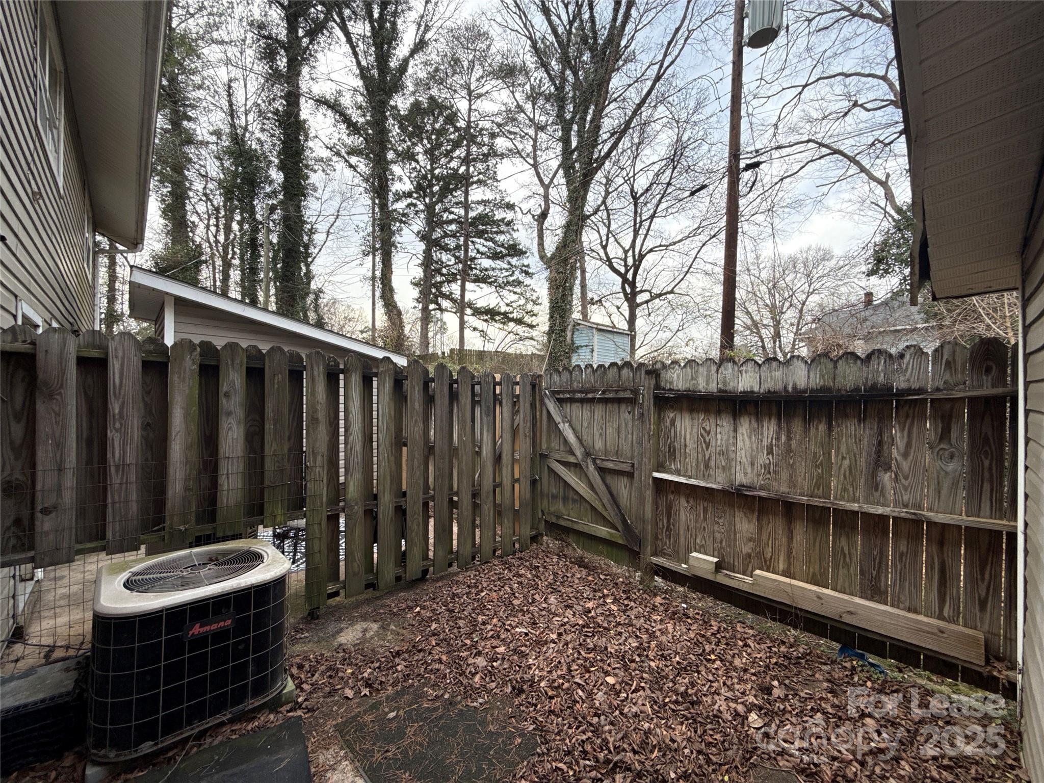 1613 North Sharon Amity Road, Unit H Charlotte, NC 28205 - Photo 12 of 13 a backyard of a house with table and chairs
