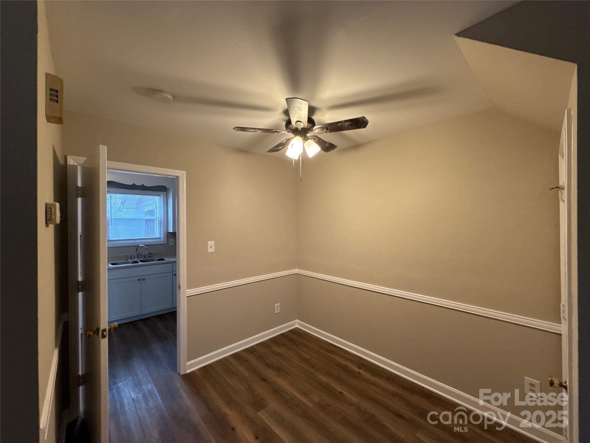 1613 North Sharon Amity Road, Unit H Charlotte, NC 28205 - Photo 3 of 13 wooden floor in an empty room with a window