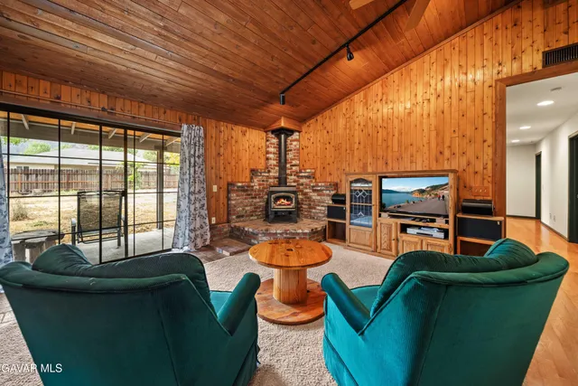 a dining room with furniture and a large window