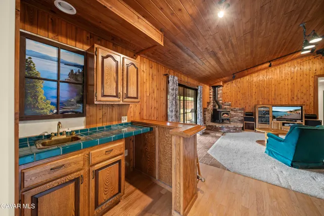 a kitchen with lots of counter top space and wooden floor