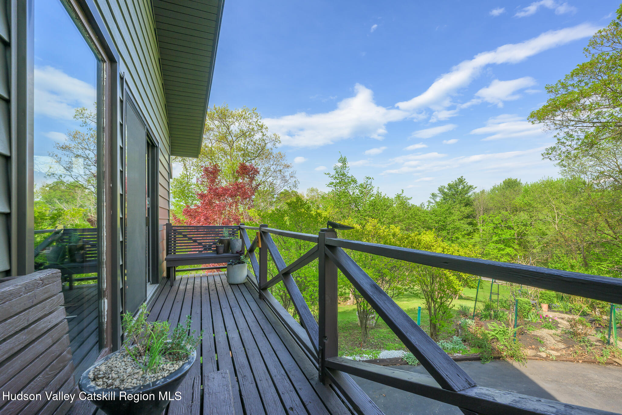 29 Edgemere Hill Road Catskill, NY 12414 - Photo 26 of 38 a view of a balcony with wooden floor and outdoor seating
