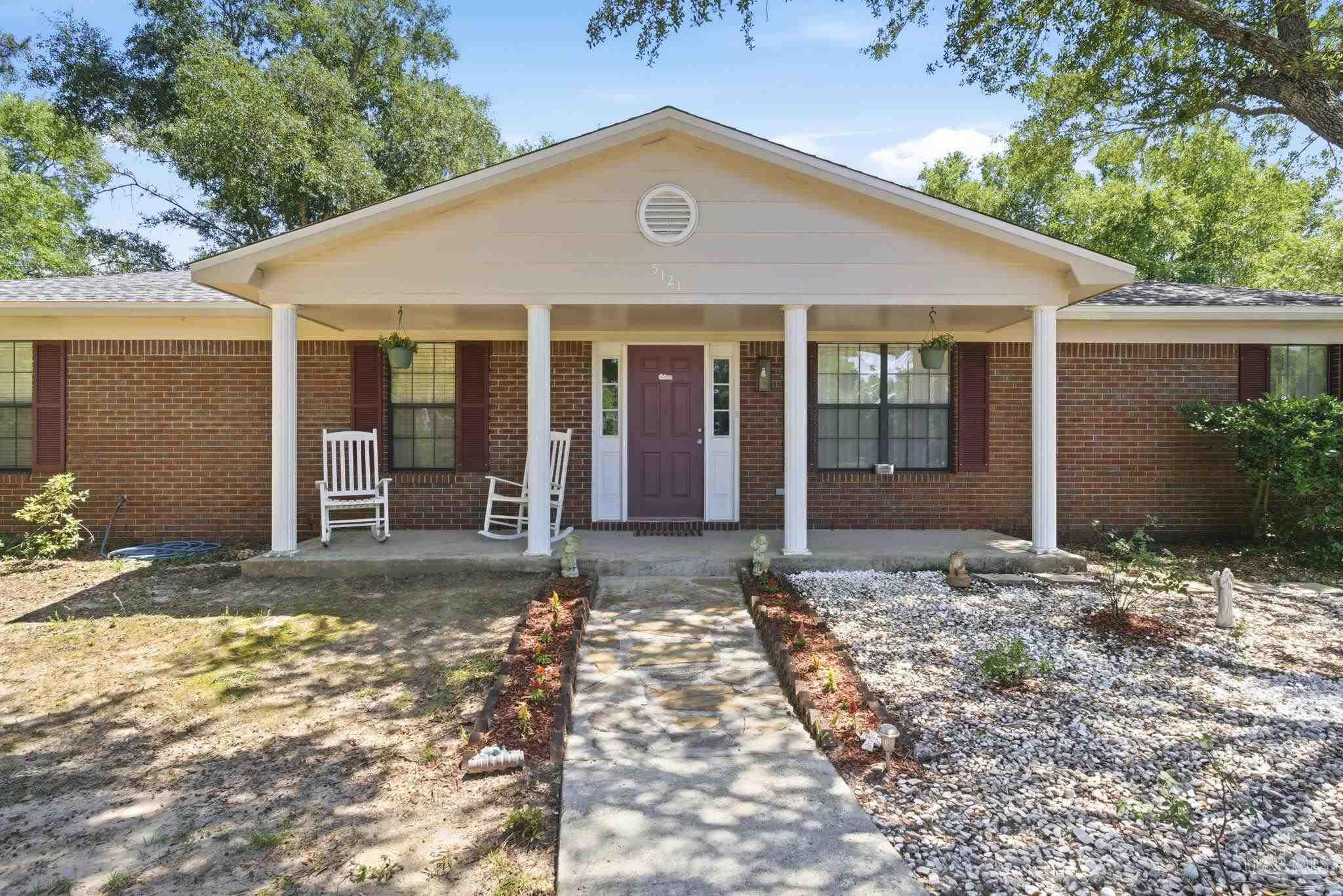5121 Keyser Mill Road Baker, FL 32531 - Photo 4 of 52 a front view of a house with garden
