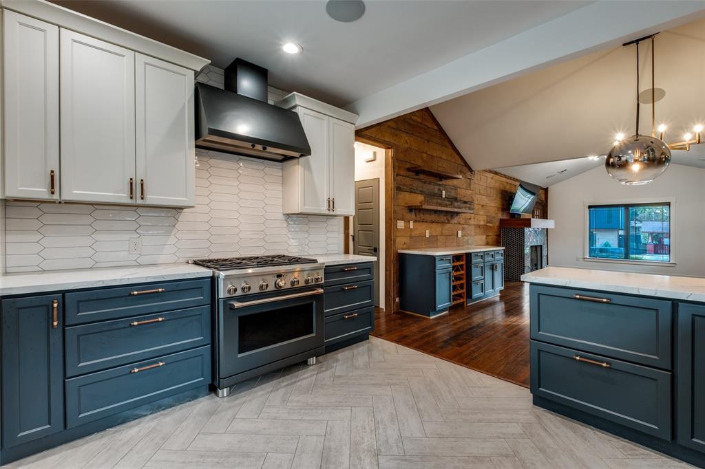 5819 Prospect Avenue Dallas, TX 75206 - Photo 12 of 25 a kitchen with stainless steel appliances granite countertop a stove and a refrigerator