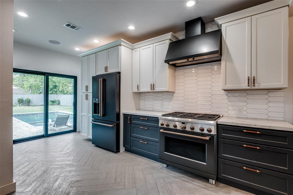 5819 Prospect Avenue Dallas, TX 75206 - Photo 13 of 25 a kitchen with stainless steel appliances granite countertop a stove a refrigerator and a microwave