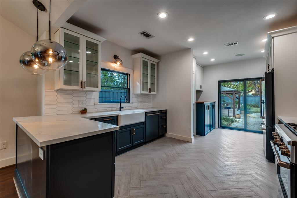 5819 Prospect Avenue Dallas, TX 75206 - Photo 14 of 25 a spacious bathroom with a sink and a large mirror