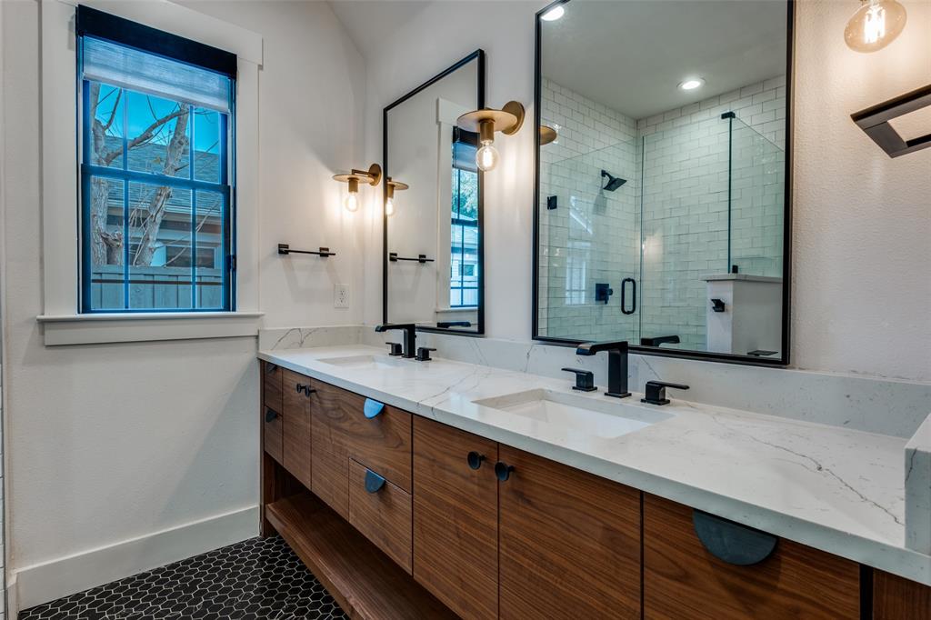 5819 Prospect Avenue Dallas, TX 75206 - Photo 17 of 25 a bathroom with a double vanity sink a mirror and a shower