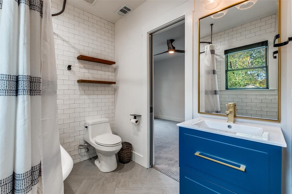 5819 Prospect Avenue Dallas, TX 75206 - Photo 21 of 25 a bathroom with a sink a toilet and shower