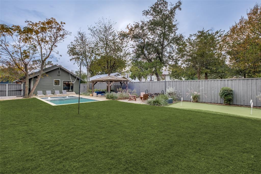 5819 Prospect Avenue Dallas, TX 75206 - Photo 24 of 25 a view of a white house and a yard with green space
