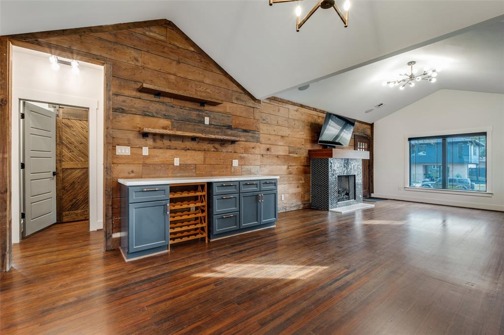 5819 Prospect Avenue Dallas, TX 75206 - Photo 6 of 25 an empty room with wooden floor fireplace and windows