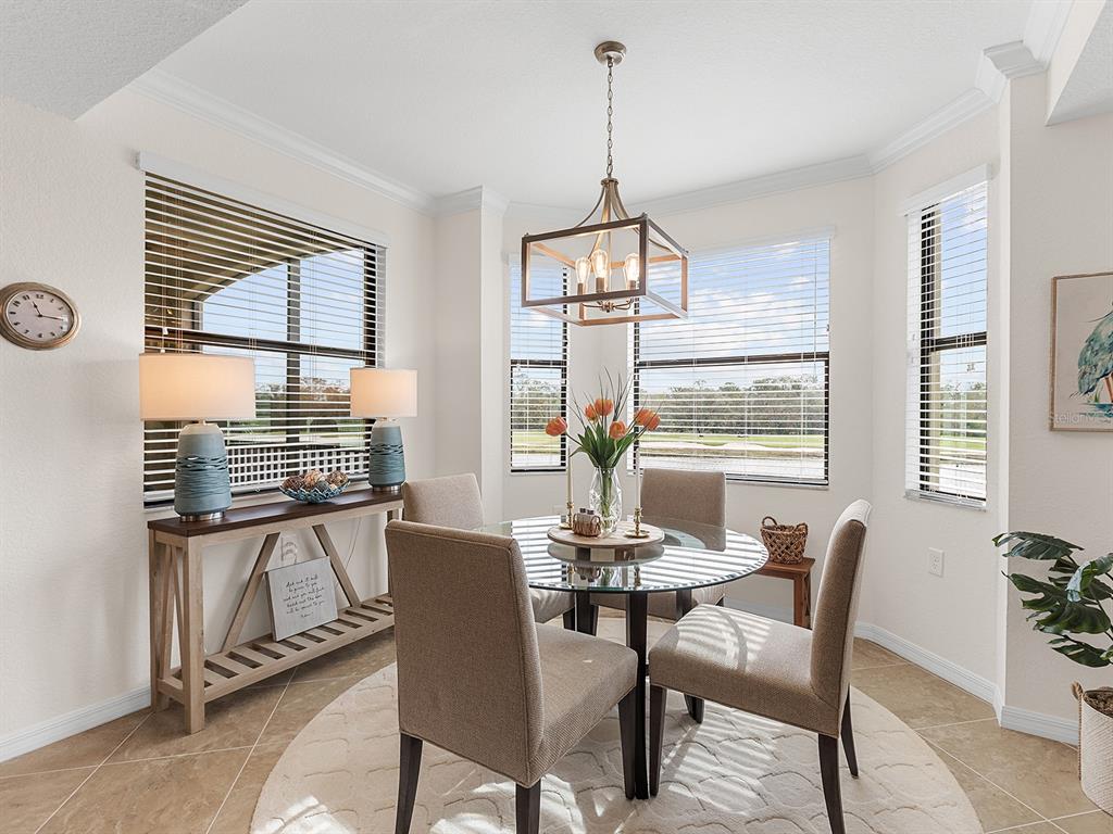 17108 Vardon Terrace, Unit 203 Lakewood Ranch, FL 34211 - Photo 20 of 50 a view of a dining room with furniture window and outside view
