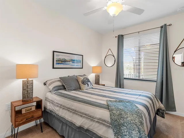 a bedroom with a bed and a lamp