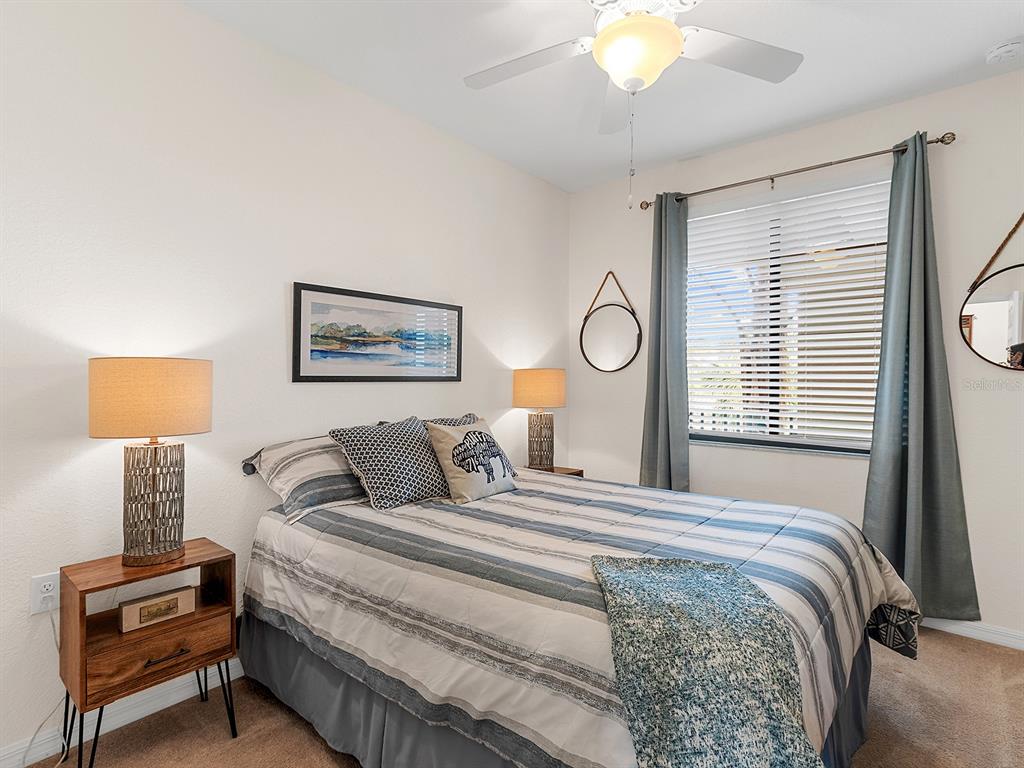 17108 Vardon Terrace, Unit 203 Lakewood Ranch, FL 34211 - Photo 26 of 50 a bedroom with a bed and a lamp