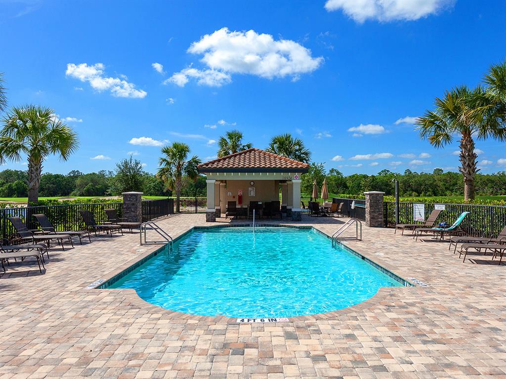 17108 Vardon Terrace, Unit 203 Lakewood Ranch, FL 34211 - Photo 29 of 50 a view of a swimming pool with a lounge chairs