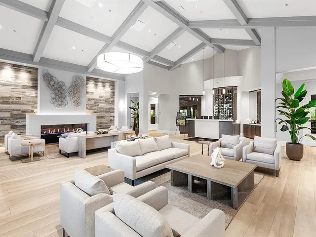 a living room with furniture fireplace and a large window