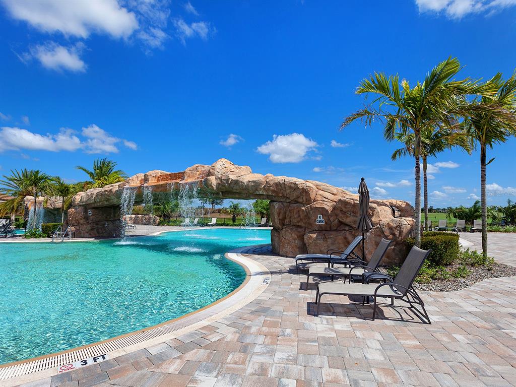 17108 Vardon Terrace, Unit 203 Lakewood Ranch, FL 34211 - Photo 49 of 50 a view of a garden with a bench in patio