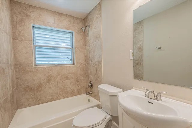 a bathroom with a sink toilet and bathtub