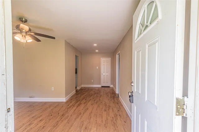 a view of a hallway with wooden floor