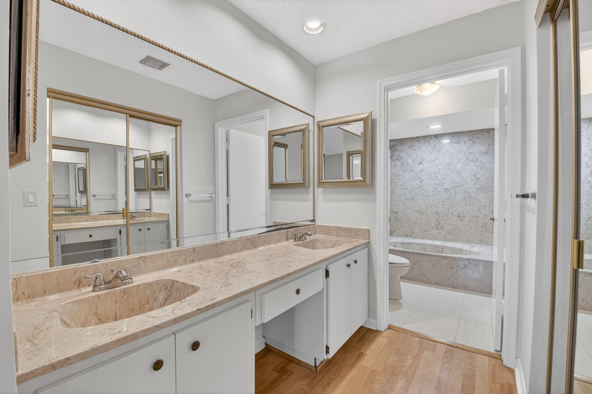 5845 Fox Hollow Drive, Unit A Boca Raton, FL 33486 - Photo 14 of 50 a bathroom with a granite countertop sink mirror and double